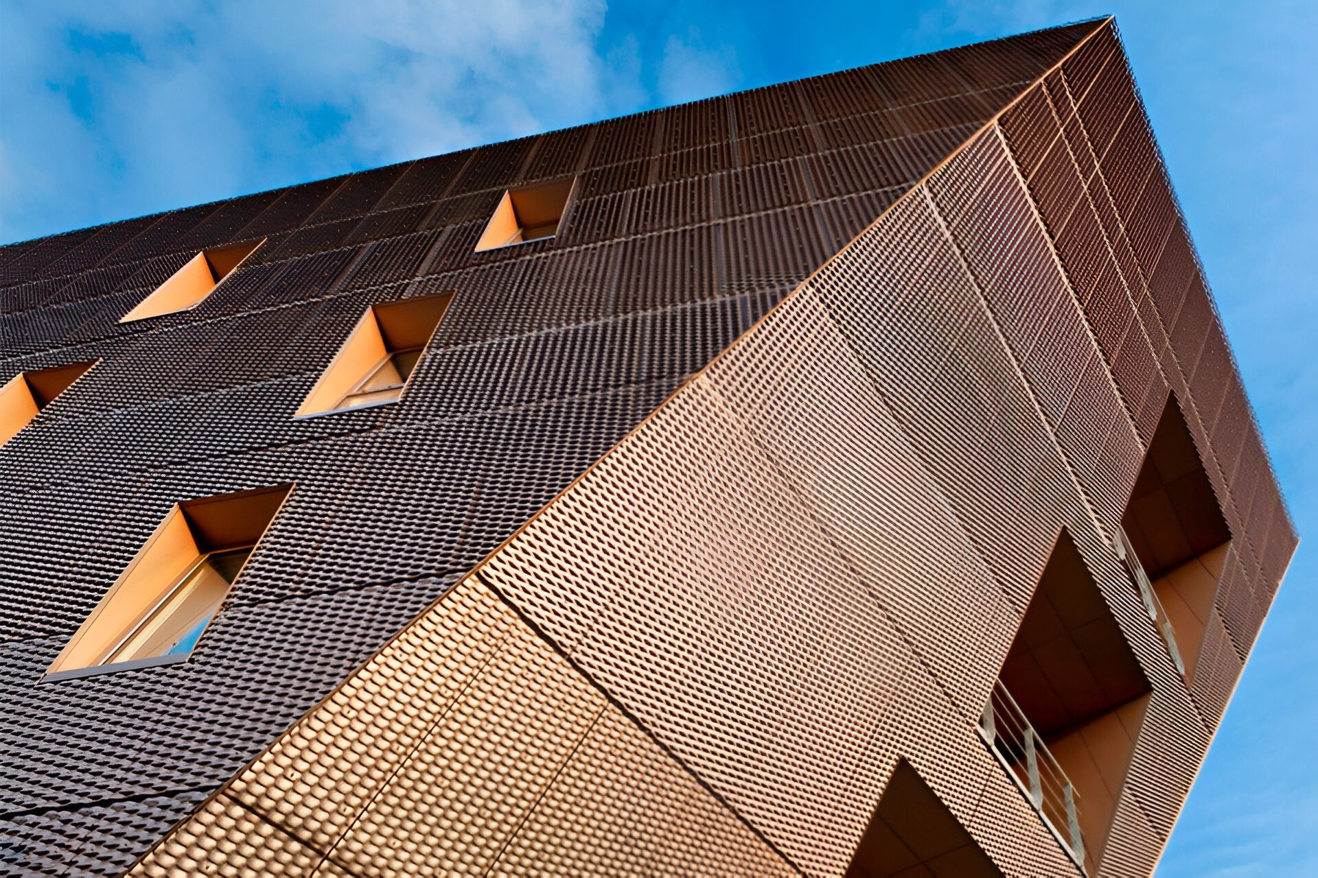 Close view of the anodised-mesh cladding at the corner of Canada Water Library, above angled first-floor windows