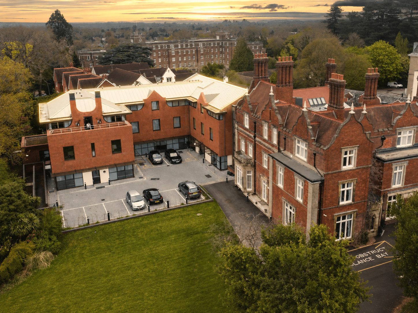 Aerial view of Mount Ephraim House with the standing-seam roof and extension roofline highlighted against the dusk sky