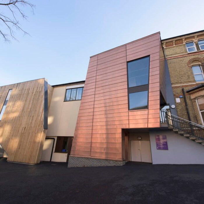 The copper-clad Performing Arts Centre extension beside Putney High School's original brick building
