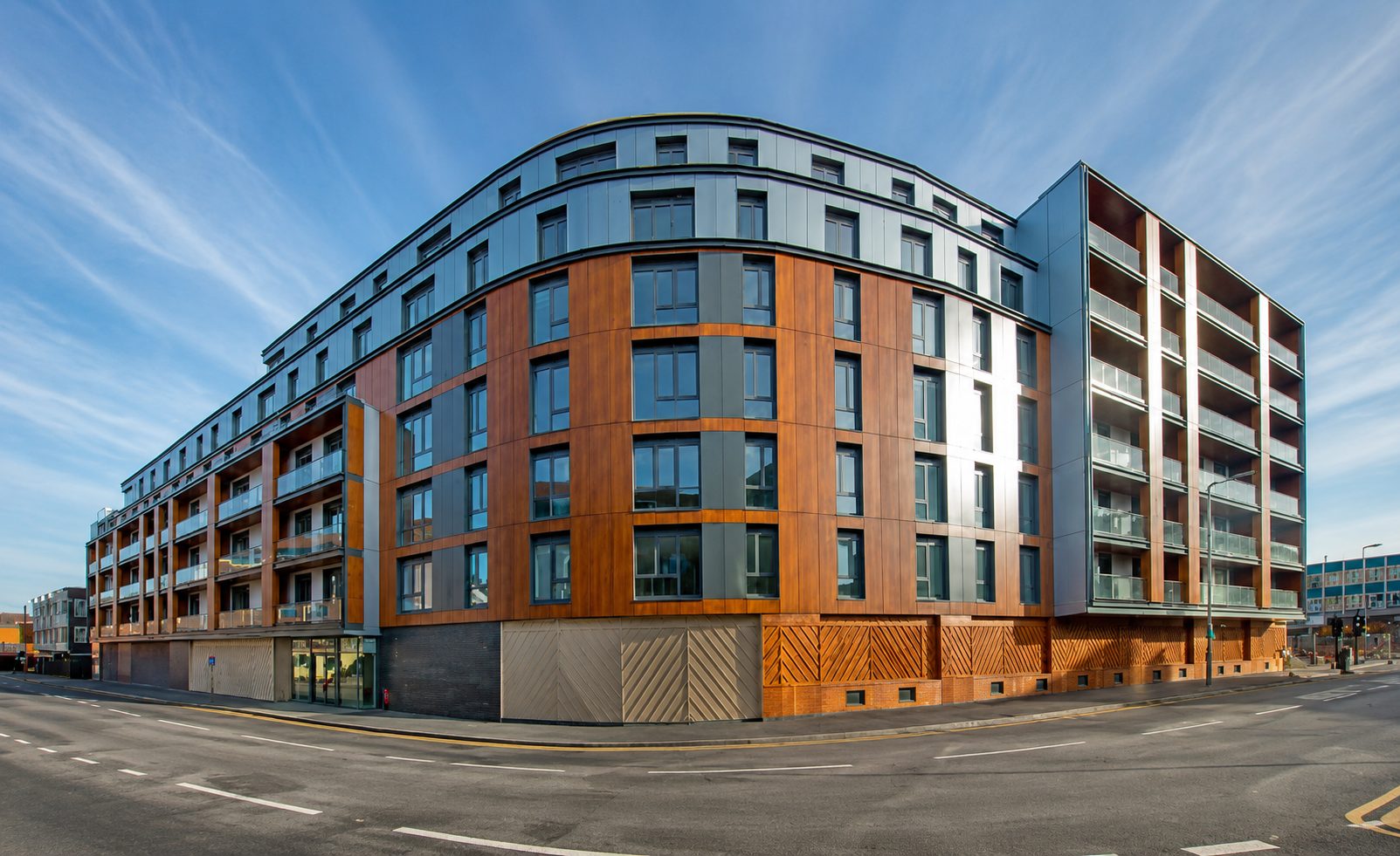 Aerial view of Nobel House's timber-effect cladding and ground-floor shops on Queensway, Redhill town centre