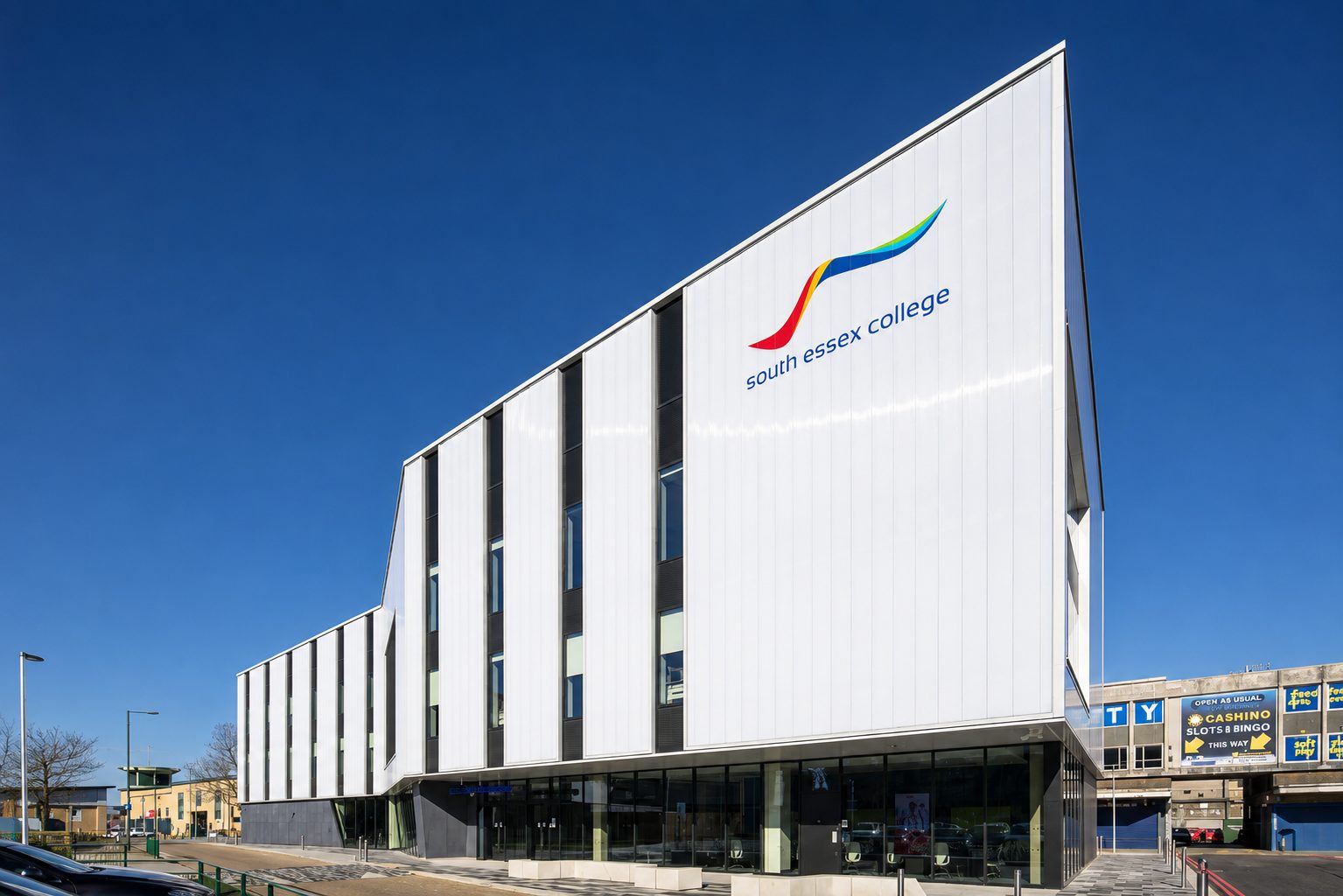 The Centre for Digital Technologies under a clear blue sky, the south essex college signage visible beside an older town-centre building