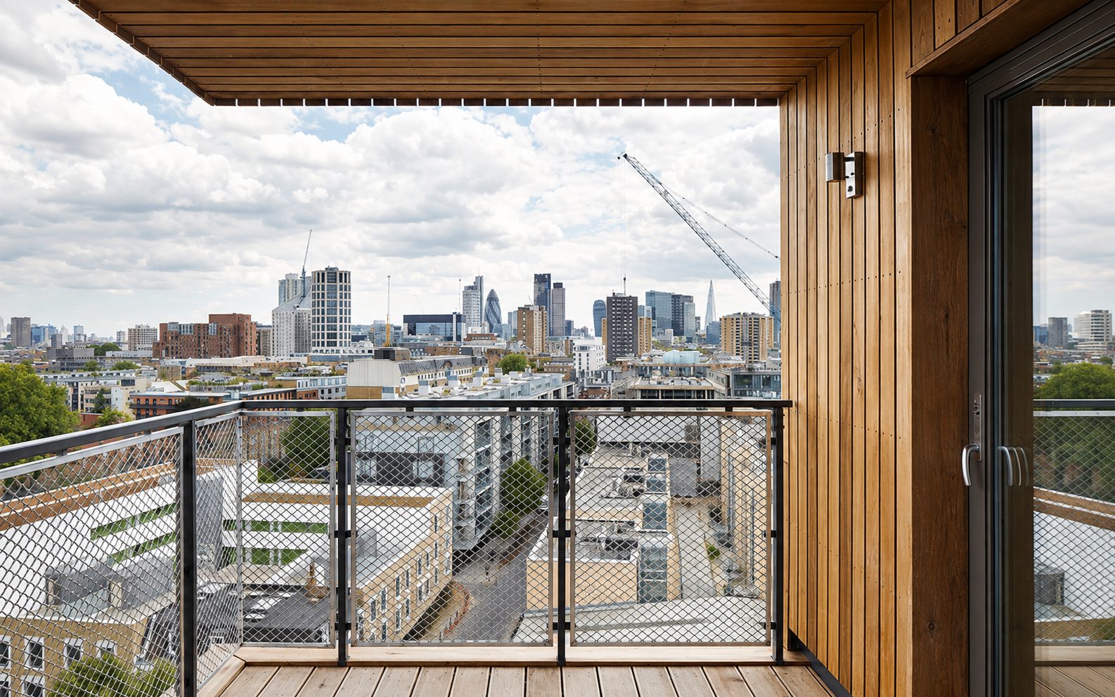 View from a private balcony at The Cube over the City of London skyline, including 30 St Mary Axe