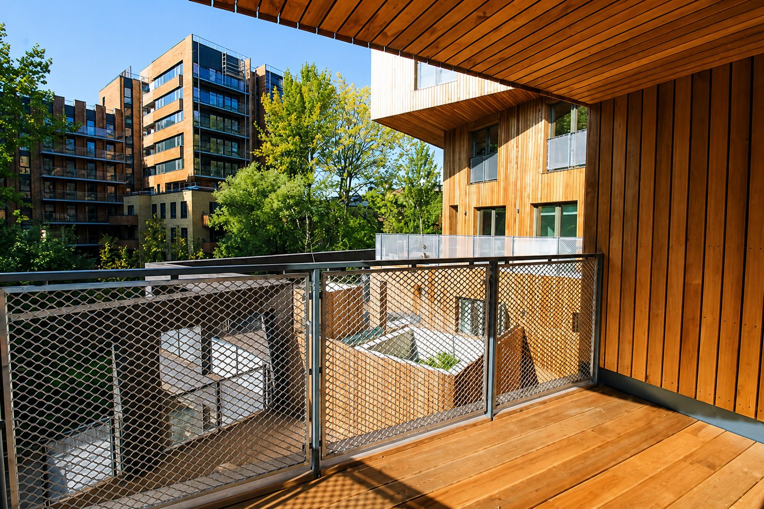 View from a balcony over The Cube's internal courtyard, cedar-clad wings arranged around a shared garden
