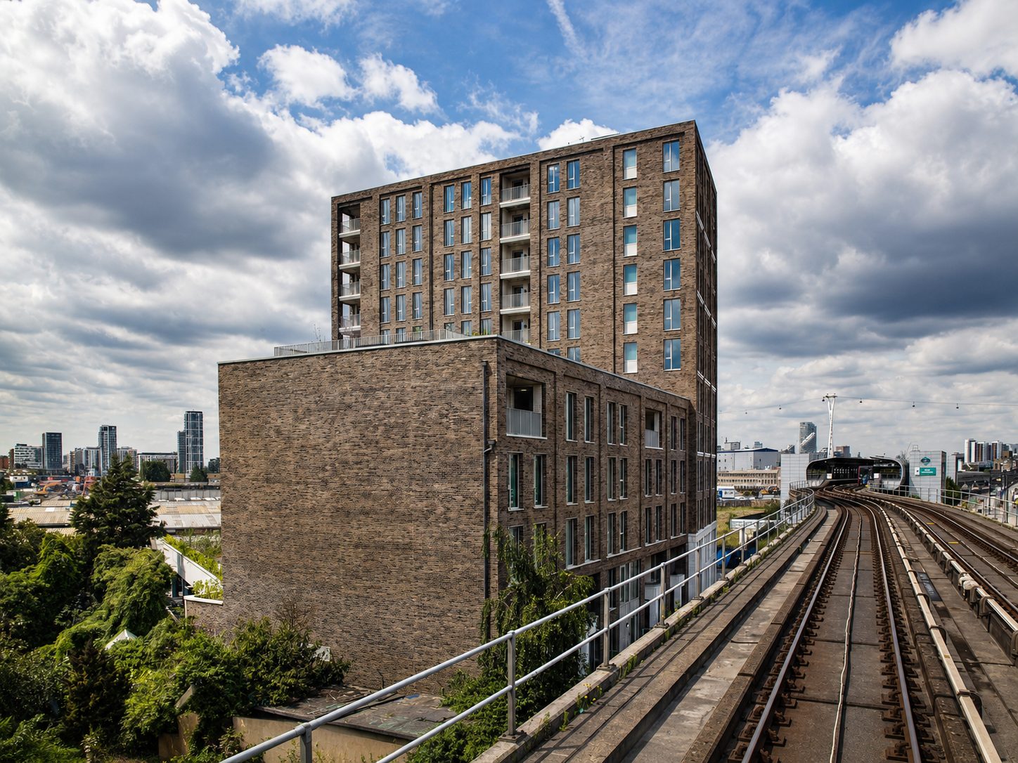 The Refinery’s tower seen from beside the elevated Docklands Light Railway as it curves towards Royal Docks