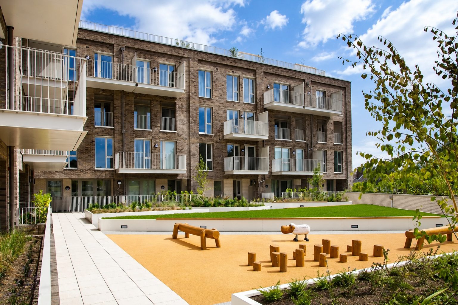 The Refinery's landscaped podium garden, with a timber-and-turf play area overlooked by residents' balconies
