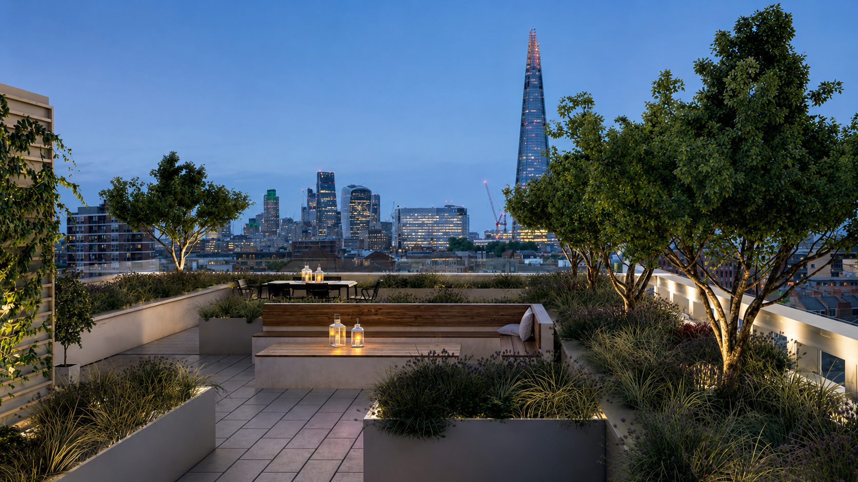 Trilogy's communal roof garden at dusk, planted seating areas with the Shard and City skyline beyond