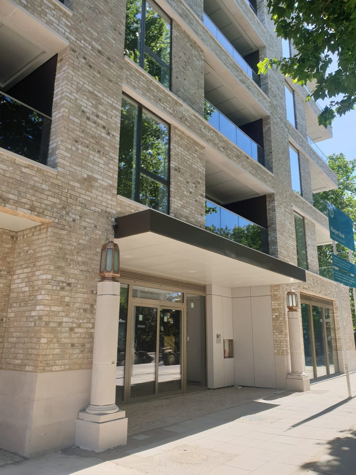 Trilogy's entrance on Harper Road, its brick piers and lanterns either side of the glazed door