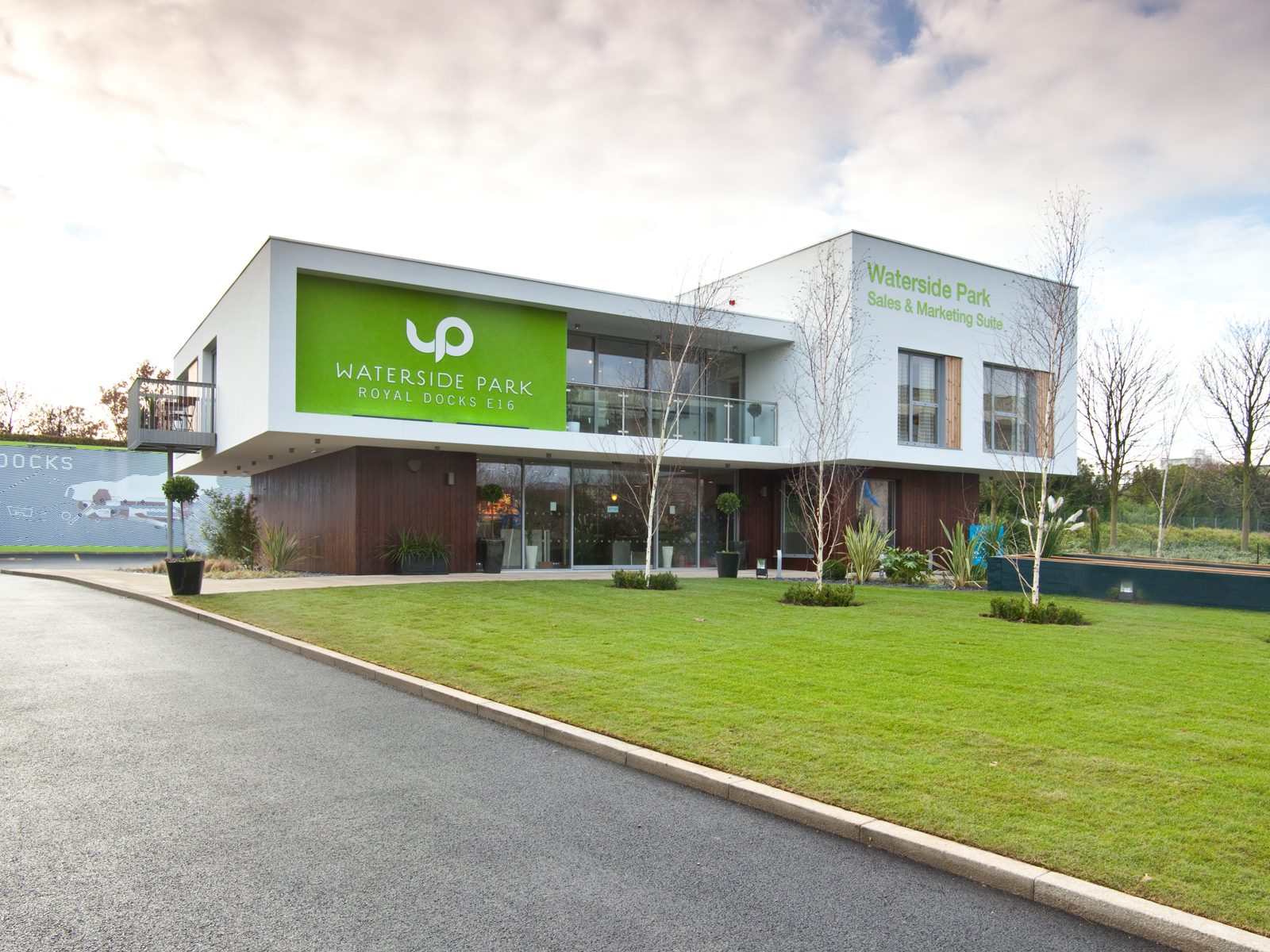 Waterside Park's Sales & Marketing Suite by day, showing its cantilevered white upper floor and Royal Docks E16 signage